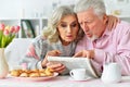 Close up portrait of happy senior couple reading newspaper Royalty Free Stock Photo