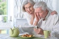 Portrait of happy senior couple reading newspaper Royalty Free Stock Photo