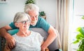 Happy senior couple relax at home on the armchair respecting the quarantine for Covid-19 - Stay at home concept