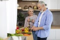 Happy Senior Couple Relaxing At Home, Cooking Healthy Food And Drinking Tea Royalty Free Stock Photo