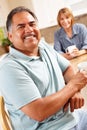 Happy senior couple relaxing in kitchen Royalty Free Stock Photo