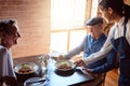 Happy senior couple at restaurant, waitress service with smile, and ready to eat healthy food with glass of champagne to Royalty Free Stock Photo