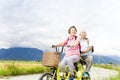 Happy Senior Couple Riding Bicycle on country road