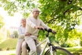 Happy senior couple riding on bicycle at park Royalty Free Stock Photo