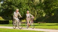 Happy senior couple riding bicycles at summer park Royalty Free Stock Photo