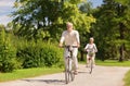 Happy senior couple riding bicycles at summer park Royalty Free Stock Photo