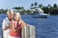 Happy Senior Couple By River Or Sea With Boat