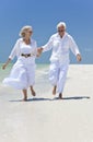 Happy Senior Couple Running on A Tropical Beach Royalty Free Stock Photo