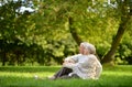 Portrait of happy senior couple sitting in autumn park Royalty Free Stock Photo