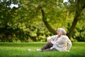 Happy senior couple sitting in autumn park Royalty Free Stock Photo