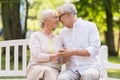 Happy senior couple sitting on bench at park Royalty Free Stock Photo