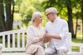 Happy senior couple sitting on bench at park Royalty Free Stock Photo