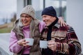 Happy senior couple sitting on terrace and drinking coffee together. Royalty Free Stock Photo