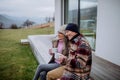 Happy senior couple sitting on terrace and drinking coffee together. Royalty Free Stock Photo