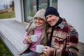 Happy senior couple sitting on terrace and drinking coffee together. Royalty Free Stock Photo