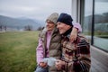 Happy senior couple sitting on terrace and drinking coffee together. Royalty Free Stock Photo