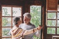 Happy senior couple smile and dance at home enjoying love and relationship together. Active old man and woman have fun in indoor Royalty Free Stock Photo