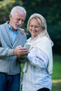 Happy senior couple smiling outdoors in nature Royalty Free Stock Photo