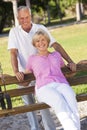 Happy Senior Couple Smiling On Park Bench Royalty Free Stock Photo