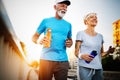 Happy senior couple staying fit by sport running