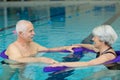 Happy senior couple swimming in pool Royalty Free Stock Photo