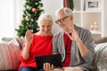 Happy senior couple with tablet pc at christmas Royalty Free Stock Photo