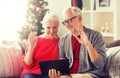Happy senior couple with tablet pc at christmas Royalty Free Stock Photo