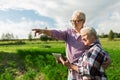 Happy senior couple with tablet pc at summer farm Royalty Free Stock Photo