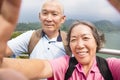 Happy senior couple taking picture with smart phone selfie Royalty Free Stock Photo