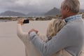 Happy senior couple taking selfie with mobile phone standing at the beach Royalty Free Stock Photo