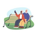 Happy senior couple taking selfie sitting on a bench in the park. Elderly man and woman lead an active lifestyle