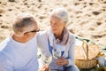 Happy senior couple talking on summer beach Royalty Free Stock Photo