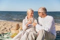 Happy senior couple talking on summer beach Royalty Free Stock Photo