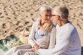 Happy senior couple talking on summer beach Royalty Free Stock Photo
