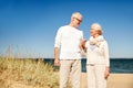 Happy senior couple talking on summer beach Royalty Free Stock Photo