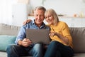 Happy Senior Couple Using Laptop Browsing Internet Together At Home Royalty Free Stock Photo