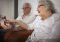 Happy senior couple using modern tablete