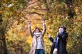 Senior couple on a walk in a forest in an autumn nature, having fun. Royalty Free Stock Photo