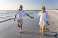 Happy Senior Couple Walking Holding Hands Tropical Beach Royalty Free Stock Photo