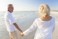 Happy Senior Couple Walking Holding Hands Tropical Beach Royalty Free Stock Photo