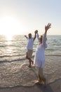 Happy Senior Couple Walking Holding Hands Tropical Beach Royalty Free Stock Photo