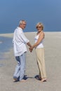 Happy Senior Couple Walking Holding Hands Tropical Beach Royalty Free Stock Photo