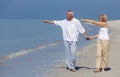 Happy Senior Couple Walking Pointing Holding Hands Beach Royalty Free Stock Photo