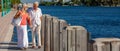 Happy Senior Couple Walking By The Sea in Tropical Resort Panorama Royalty Free Stock Photo