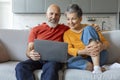 Happy Senior Couple Watching Movie On Laptop At Home Royalty Free Stock Photo