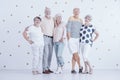 Happy senior couples enjoying meeting against white wall with go Royalty Free Stock Photo