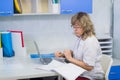 Happy senior doctor with clipboard at hospital reception Royalty Free Stock Photo