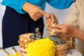 Happy senior elder woman teaching knitting woven craft other old female mature togehter at home Royalty Free Stock Photo