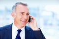 Happy senior executive on phone call. Business man smiling as he talks on cell phone. Royalty Free Stock Photo