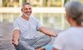 Happy senior family couple meditating together outdoors during morning yoga practice Royalty Free Stock Photo